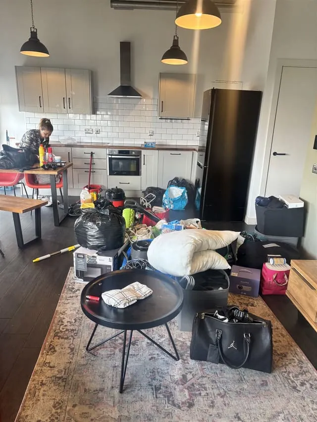 Lewisham flat kitchen and living area before the clean, with belongings still in the room